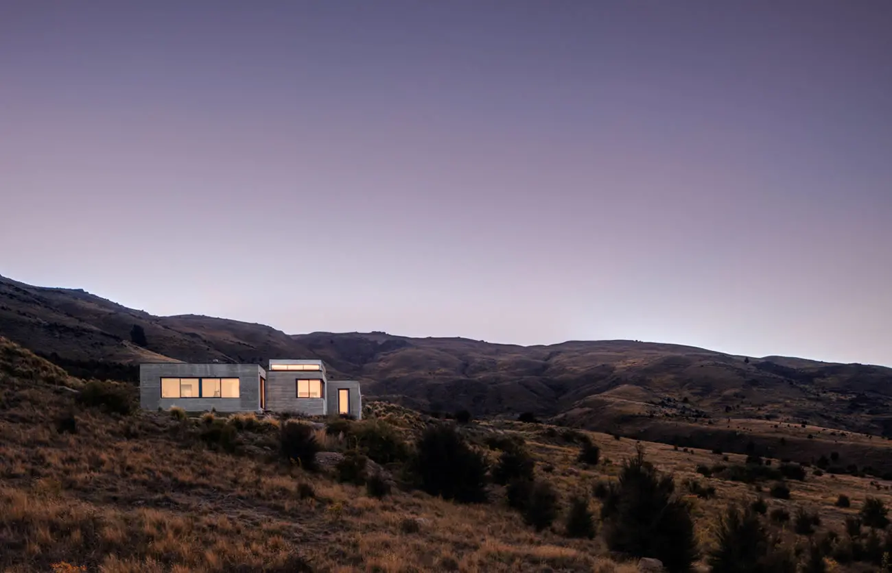 Modern house in the mountains at dusk