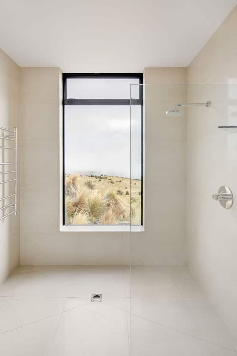 Shower with large window opening out at the view